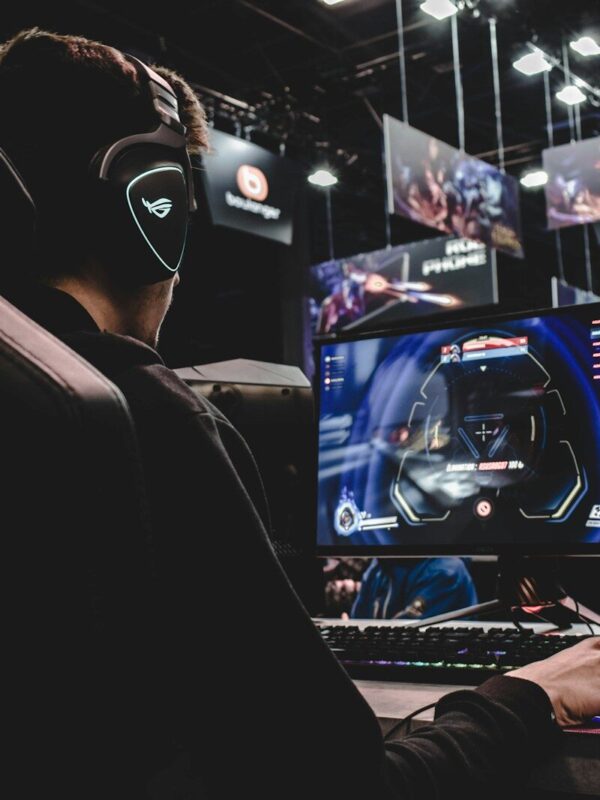 person sitting on gaming chair while playing video game